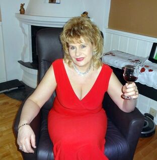 Cool  granny toying the piano and guzzling wine from a